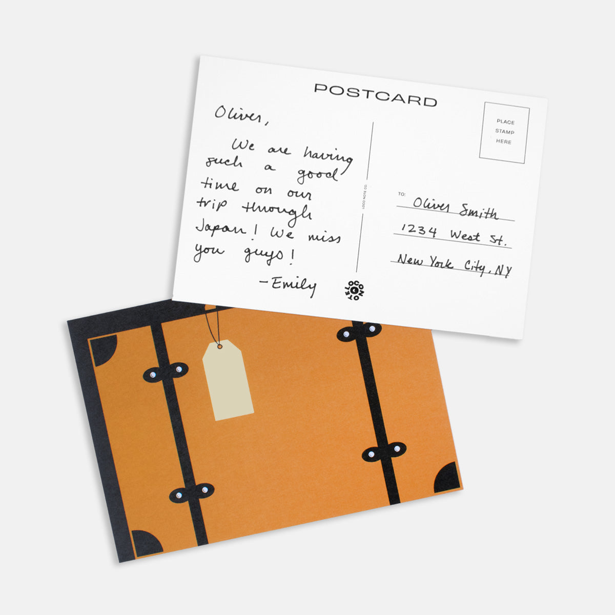 Suitcase postcard with handwritten message and luggage tag design, perfect for travel-themed correspondence.