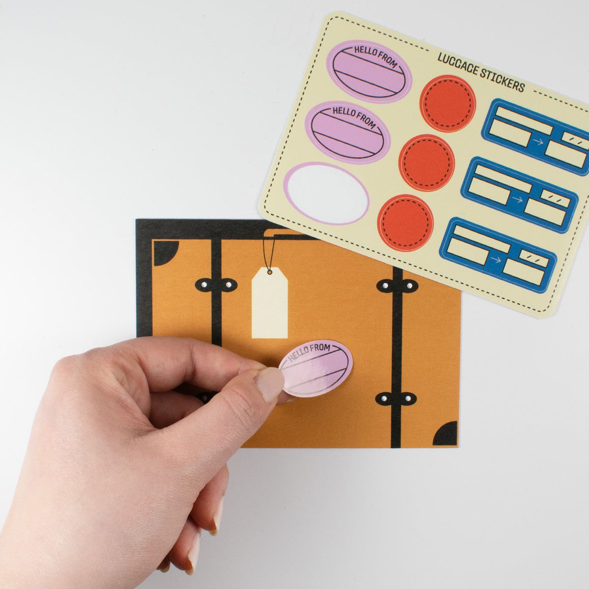 Suitcase postcard with luggage stickers featuring travel themes and personalization options for sending messages.