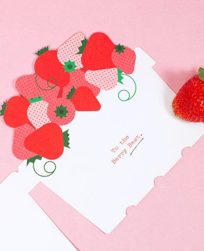 Opened Love and Friendship Card featuring a basket of fresh strawberries on a pastel pink background with a little strawberry.